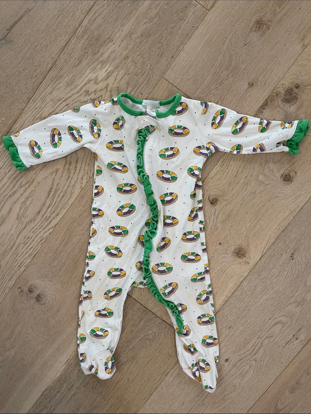 La Luna Footed One-Piece Pajamas with Green Ruffled Trim And King Cake Motifs